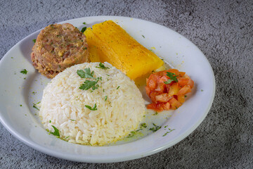 Rice and beans, traditional brazilian dish with manioc and salad.