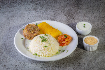 Rice and beans, traditional brazilian dish with manioc and salad.