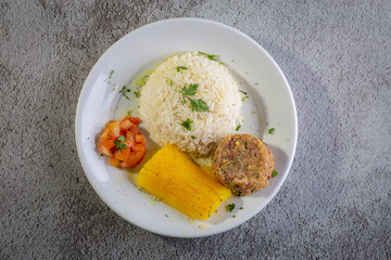 Rice and beans, traditional brazilian dish with manioc and salad.