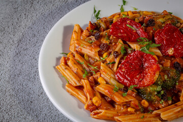 Penne pasta with tomato sauce and vegetables