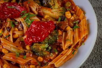 Penne pasta with tomato sauce and vegetables