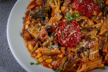 Penne pasta with tomato sauce and vegetables