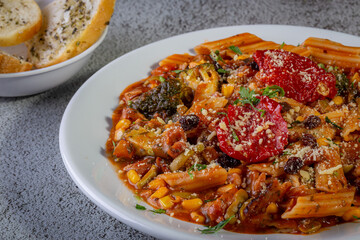 Penne pasta with tomato sauce and vegetables