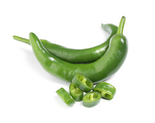 Cut and whole green hot chili peppers on white background