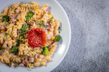 Penne pasta with bechamel sauce and vegetables