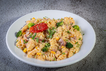 Penne pasta with bechamel sauce and vegetables