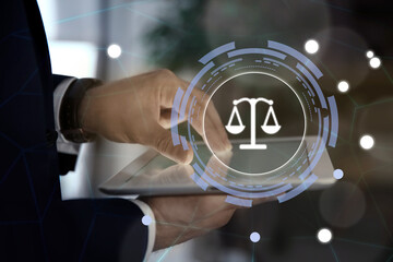 Scales icon and lawyer using tablet at workplace, closeup