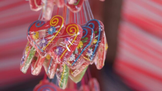 Gingerbread hearts hanging below the festivals red-and-white striped tent.