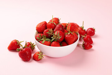 Bowl with tasty strawberry on pink background. Summer berry