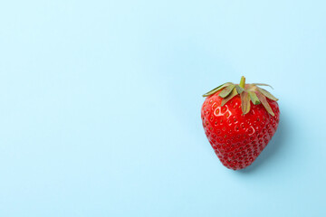 Tasty strawberry on blue background. Summer berry