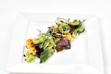 Big tasty food lies on white plate on isolate