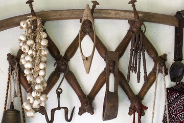 Antique wooden hanger with rustic objects in a country house.
