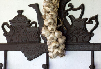 Wall decoration in a country house, braided old garlic.