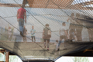 uilding with a floor that allows people to walk in a vacuum thanks to a net made of steel ropes and...