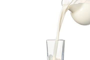 milk is poured from a glass carafe into a glass on a white background