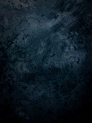 Blue dark wall, stucco, dark concrete. Dark decorative stone. Floodlight. Empty night wall, neon blue light.