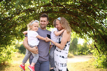 Happy loving family with two children, son and daughter playing and hugging. Family walk. Happy...