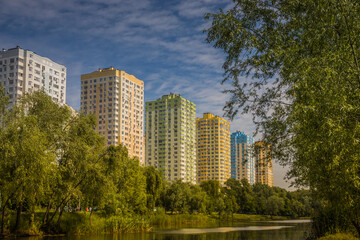 Landscape from sity park, Kyiv. Ukraine. Little river, hot summer, bright green trees and high buildings
