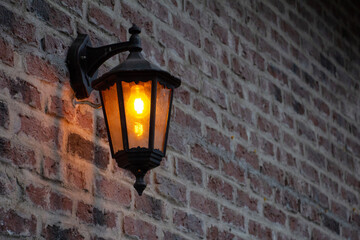 old vintage street lamp on brick wall