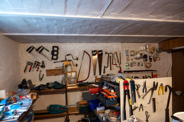 Workshop - view of a wall in a basement room with various tools 