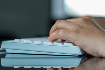 hands of a woman on white keyboard