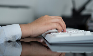 hands of a woman on white keyboard