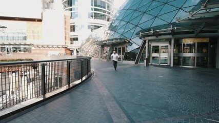 Young man runs. Handsome guy in hurry to meeting. Slow motion