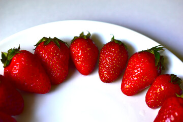 Sliced strawberries or Victoria on a white plate