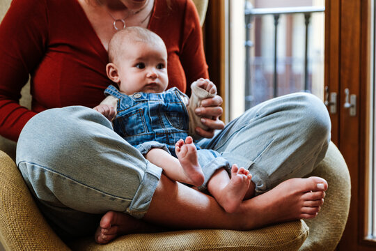 Mother with baby sitting near window