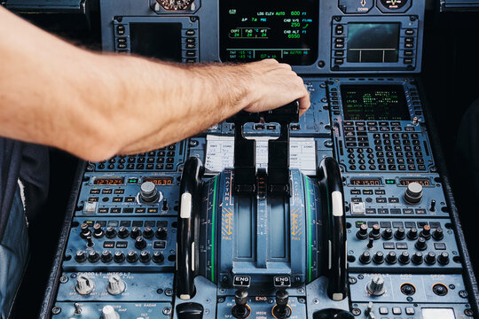Pilot operating airplane in cockpit