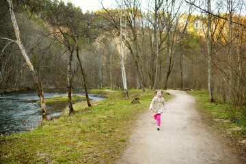 Cute young girl having fun on beautiful spring day. Active family leisure with kids. Family fun outdoors.