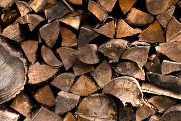 A lot of stacked chopped firewood prepared for use.
