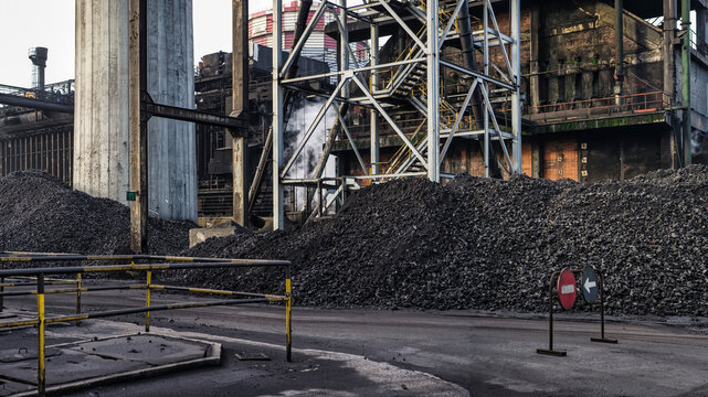Heaps of coal placed in industrial area at factory for producing coke