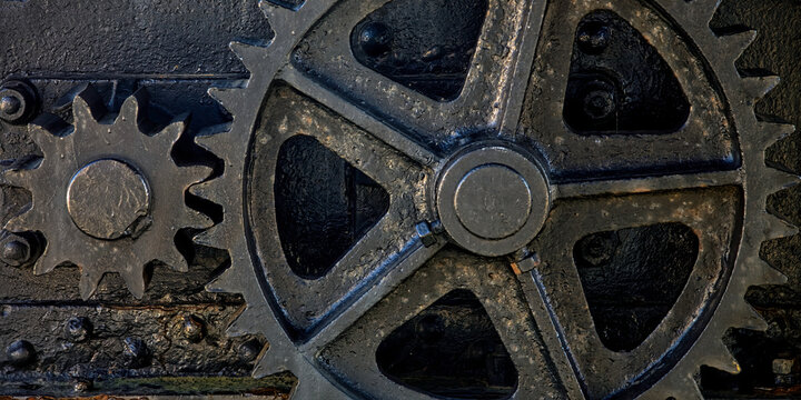 Shabby black gears of aged mechanism located in Port of San Esteban de Pravia in Spain