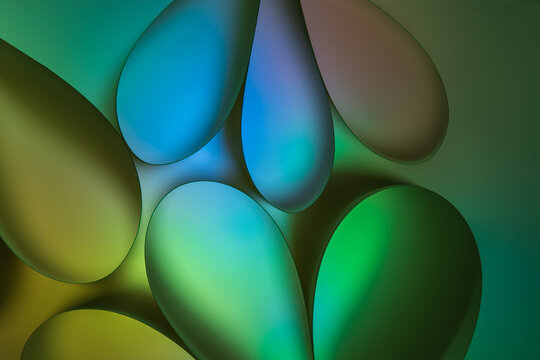 Abstract multicolored green and blue background with glowing bubbles of different shapes and colors