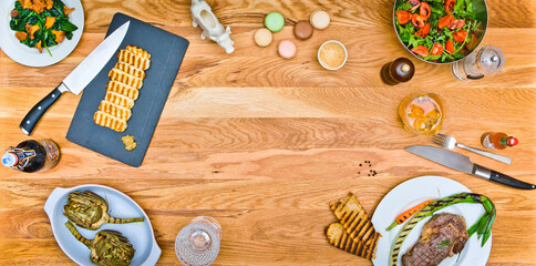 Top view of a beef steak and grilled cheese on a wooden table. salad with arugula. Grilled artichokes. Empty middle 