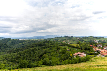 Fototapeta premium The view from the heights of the mountains, fields, and vineyards of the Italian foothills of the Alps