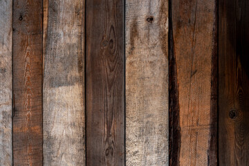 old cracked wooden fence. vertical lines. rough surface texture