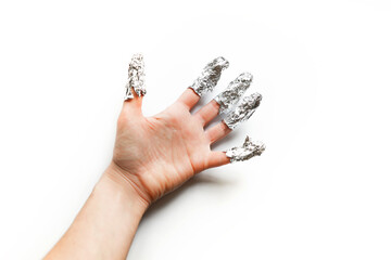 Palm with fingers covered with foil, gel nail polish removing with foil