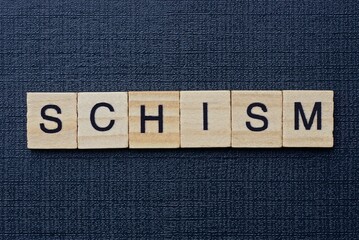  text on word schism from gray wooden letters on a black background