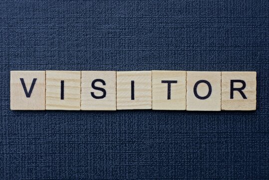  text on word visitor from gray wooden letters on a black background