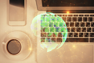 Social network hologram drawings over computer on the desktop background. Top view. Double exposure.