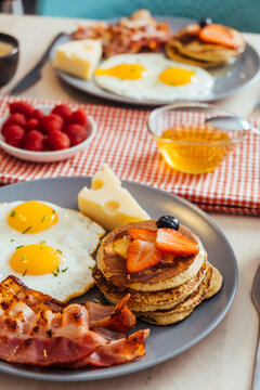 Delicious fried eggs with bacon and cheese for breakfast