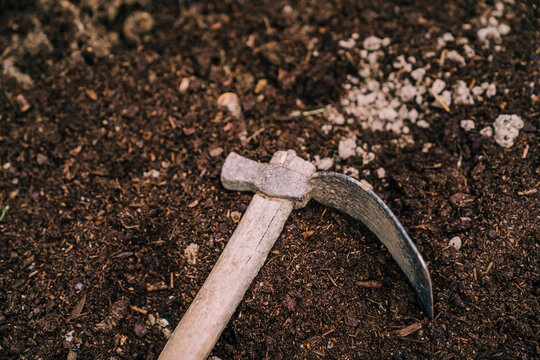 Mattock placed on ground in garden