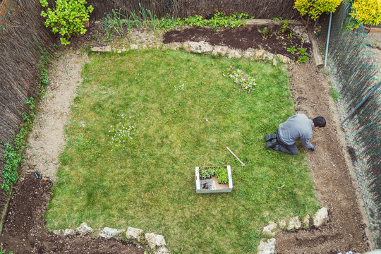 Man working with rake in garden