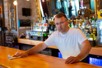 Bartender Cleaning the Bar.