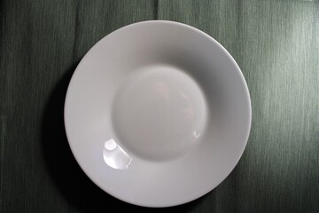 Empty plate on a dark blue background view from above