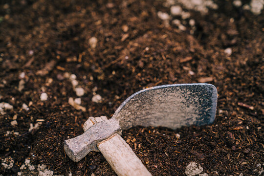 Mattock placed on ground in garden