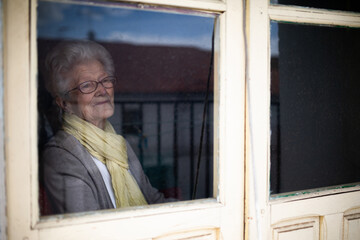 Senior woman looking out window