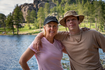 A Mom and teenage boy phase together for a picture at Sylvan Lake, South Dakota.